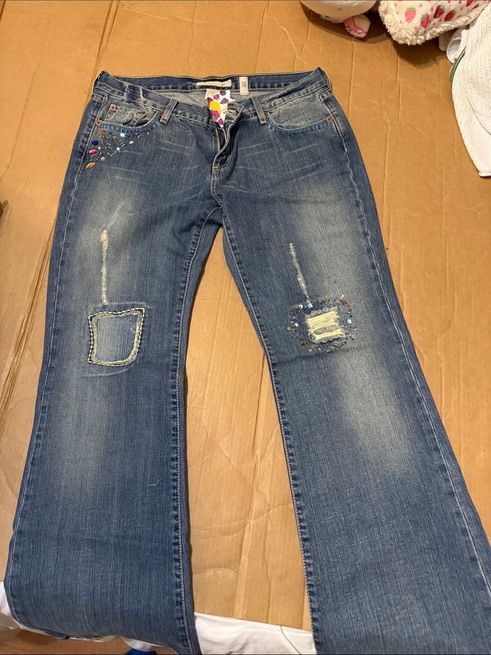 Embellished Blue Flare Jeans with Distressed Patch Details